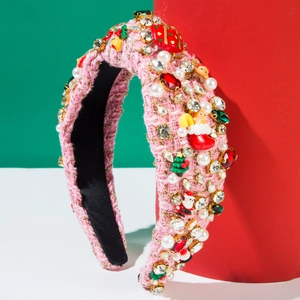 Detail of pink tweed Christmas headband with pearls, rhinestones, and resin holiday charms