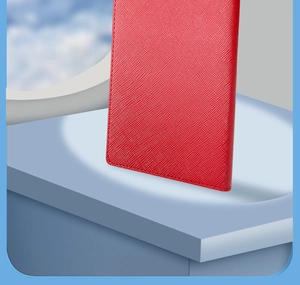 Detail of red Saffiano PU leather passport holder with slots on a travel background