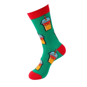 Detail of green knit crew sock with red trim and pixelated cold drink pattern design