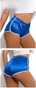 Detailed view of glossy blue athletic shorts with white contrast trim and high waist