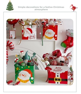 Festive Christmas gift boxes with Santa Claus and snowman motifs set on a fireplace