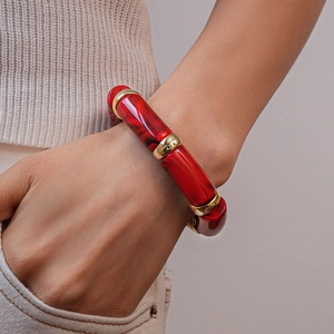 Detailed view of red marble resin bamboo bracelet with golden metallic spacer beads