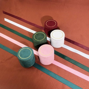 Elegant round velvet jewelry boxes with matching ribbons in multiple colors for rings