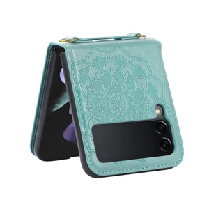 Detail of teal PU leather phone case with embossed mandala pattern and gold D-ring