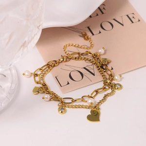 Double-layered gold chain bracelet with pearls, heart pendant and rhinestones