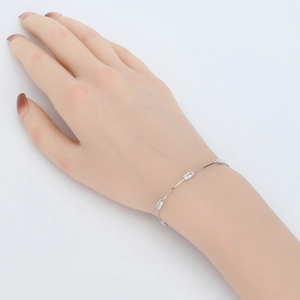 Detail of thin 925 silver bracelet with three rectangular clear zircons on model hand