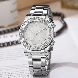 Detail of silver quartz watch featuring a grid dial and rhinestone-encrusted bezel