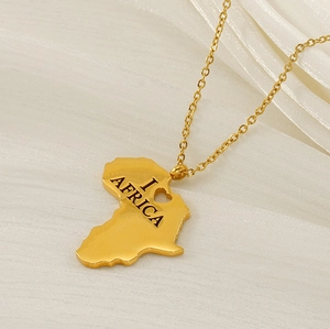 Close-up of gold-plated Africa map necklace with heart cutout and engraved lettering