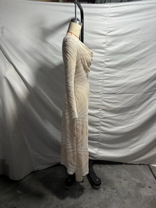 Detail of elegant sequined evening gown with wavy patterns and long sleeves