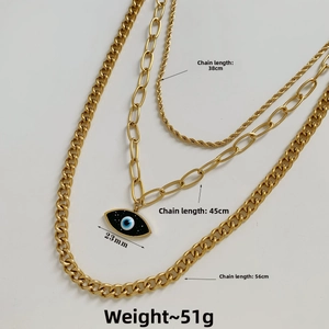 Detailed view of triple-layered golden steel chain necklace with evil eye pendant detail