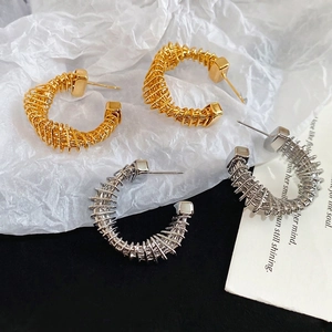Twisted C-shape hoop earrings in gold and silver finish with spiral metal texture