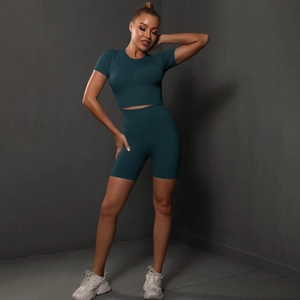 Detail of high-stretch seamless yoga set featuring crop top and high-waist shorts in dark green