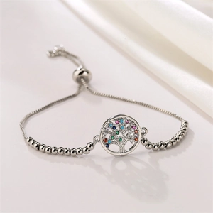 Macro detail of silver-toned adjustable Tree of Life bracelet with colorful crystals
