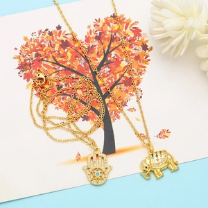 Elegant gold necklaces with Hamsa hand and elephant pendants featuring micro-paved colored stones