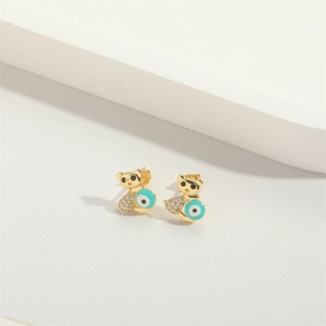 Detail of gold teddy bear earrings with turquoise evil eye and zircon stones