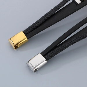 Detailed close-up of multilayer braided leather bracelet with gold and silver magnetic clasp
