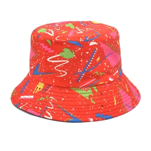 Detailed close-up of a red bucket hat with colorful retro geometric abstract patterns