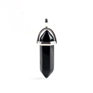 Detailed macro view of black obsidian hexagonal crystal pendant with silver clasp