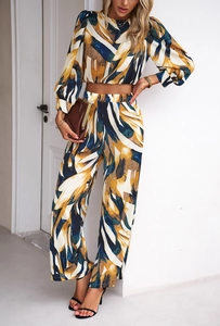 Detail view of abstract print set featuring cropped top and wide-leg trousers with side slits