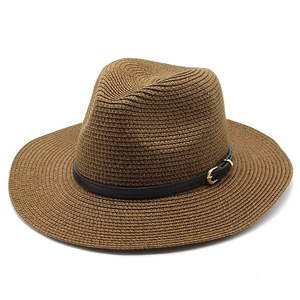 Detail of brown straw fedora featuring a black leather band and golden buckle
