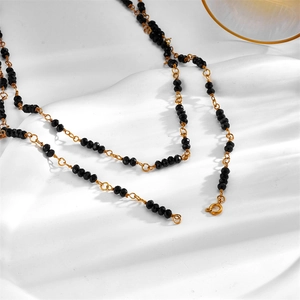 Minimalist multi-layer gold chain necklace with black faceted crystals and spring clasp