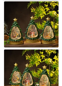 Detail view of glowing Christmas tree snow globe with Santa and swirling glitter