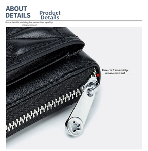 Close-up of black leather bag featuring silver star-shaped zipper and fine stitching