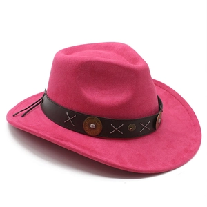Detail of rose red western cowboy hat with brown leather band and retro metal studs