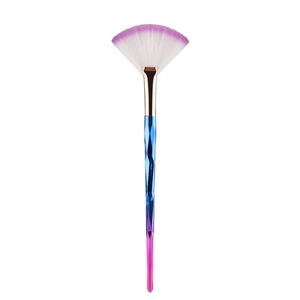 Macro shot of fan-shaped highlighter brush with blue pink gradient handle and rose gold ferrule