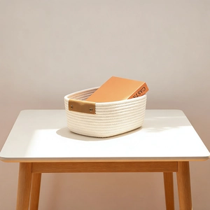 Close-up of woven cotton storage basket with brown leather handles and metal rivets
