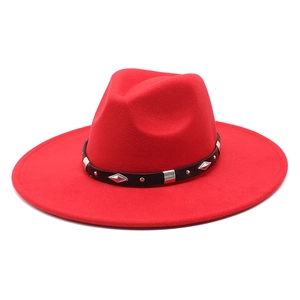 Detailed view of red wool fedora hat with black studded leather band and silver rivets