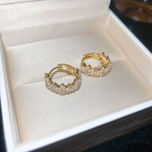 Macro detail of 14K gold plated hoop earrings with pearls and cubic zirconia in a gift box