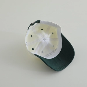 Detail of color-block baseball cap inner lining with sweatband and metal adjustment buckle