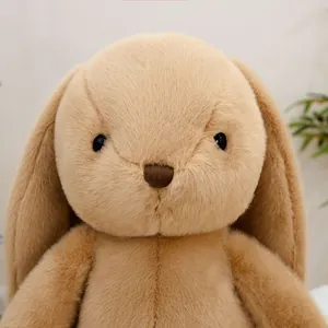 Close-up of cute plush bunny with long floppy ears and soft brown fur texture