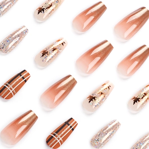Press-on nails featuring maple leaf sequins, gold glitter gradient, and plaid patterns