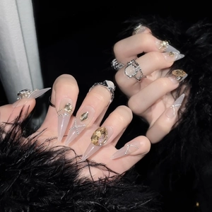 Luxurious champagne gold press-on nails with amber rhinestones and silver rings