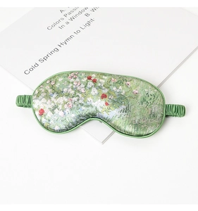 Detail of silk-like sleeping mask featuring Impressionist green floral oil painting patterns