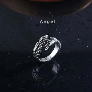 Vintage angel wing open ring in retro silver style with detailed feather texture