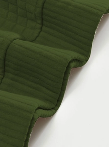 Close-up of olive green henley sweatshirt with honeycomb texture and vertical knit details