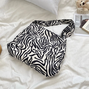 Detail shot of the zebra pattern corduroy texture and sturdy strap on the large tote bag