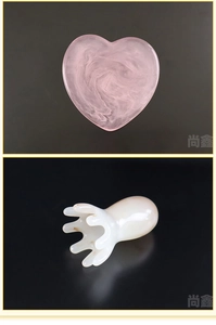 Detail view of pink heart Gua Sha tool and white resin octopus head massage comb