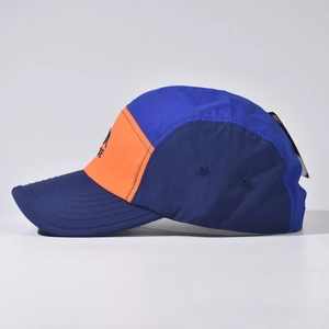 Detail of color-block mountain baseball cap in navy, royal blue and bright orange