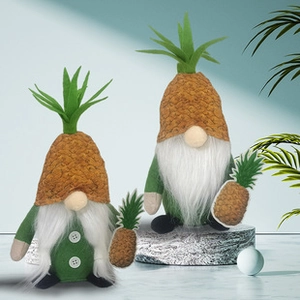 Detail view of two gnome Christmas stockings with pineapple theme and plush textures