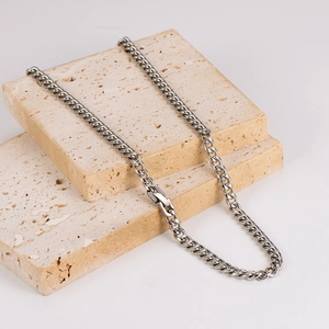 Polished silver stainless steel 6mm Cuban link necklace for men on stone display
