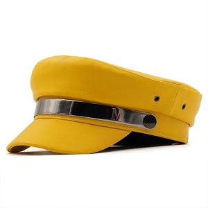 Yellow faux leather baker boy hat with silver metal bar and embossed letter M detail