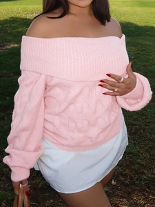 Close-up of pink off-shoulder knit sweater showing thick texture on outdoor grass
