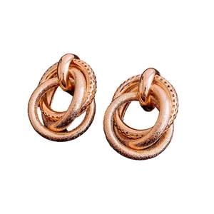 Modern rose gold interlocking hoop earrings featuring mixed polished and matte textures