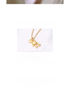 Macro detail of 3D polished golden teddy bear pendant on a titanium steel chain