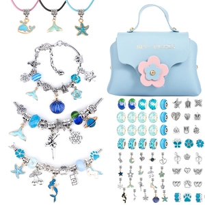 Blue DIY jewelry kit with charms, beads, necklaces, and a Best Wishes handbag
