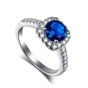 Classic 925 sterling silver ring featuring a round dark blue sapphire in a halo diamond setting